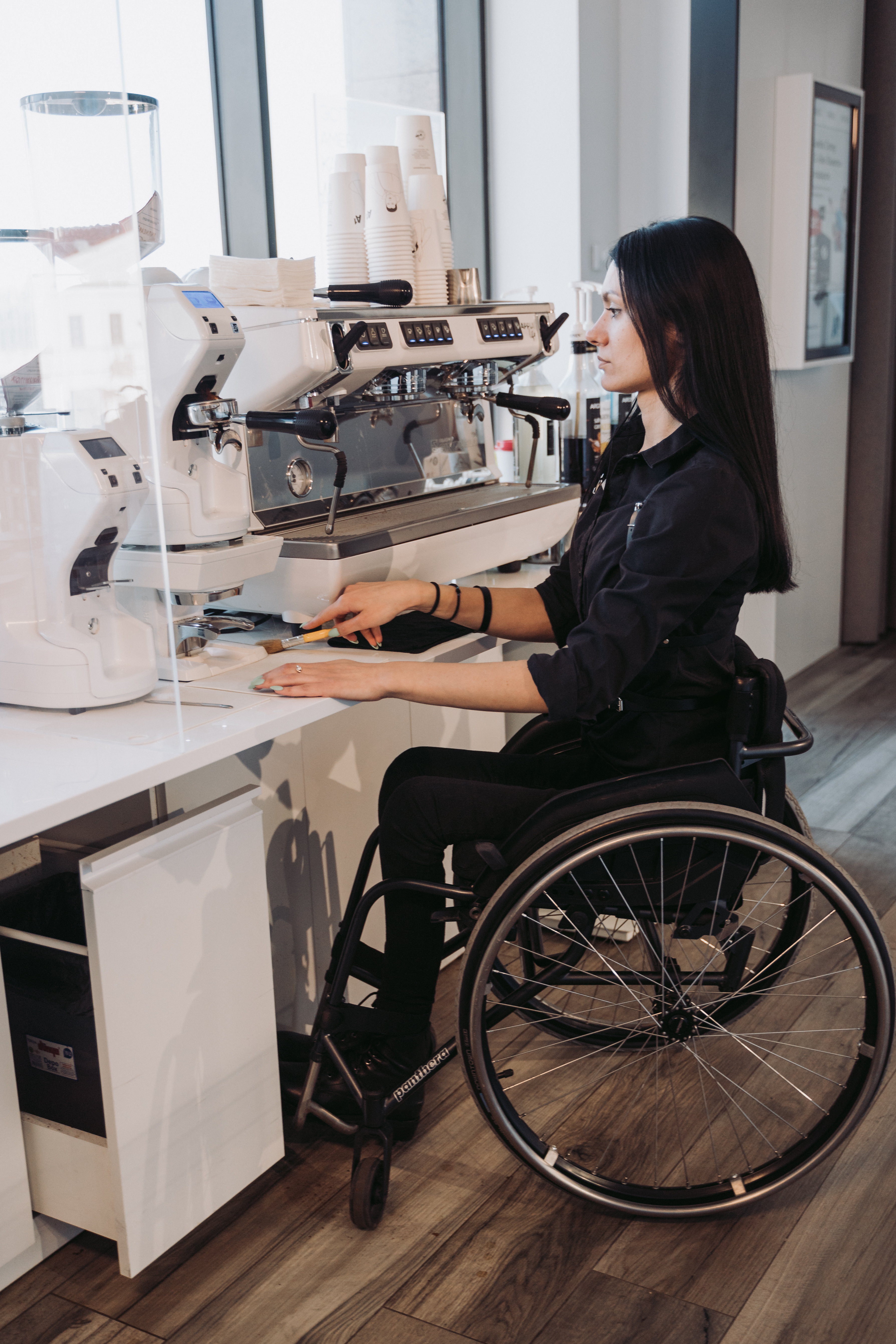 Worker in wheel chair doing work in lab